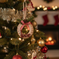 Decorative Christmas ornament on a tree with festive background