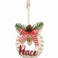Decorative Christmas ornament with 'Peace' text, pine cone, and bell on a white background