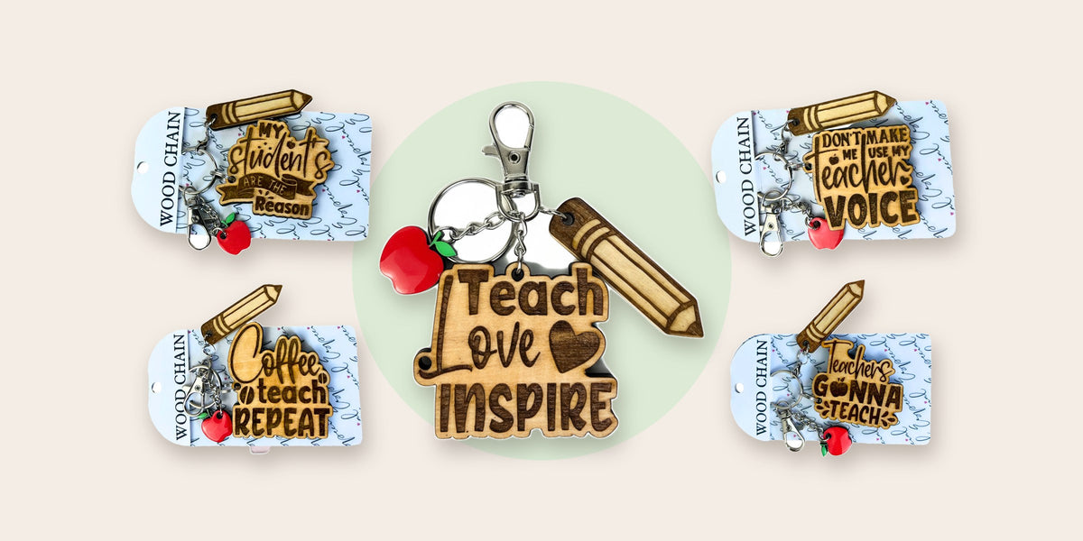 Handmade wooden teacher keychains with engraved messages and an apple charm