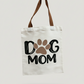 Tote bag with 'Dog Mom' and paw print design on a white background