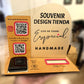 Souvenir Design wooden payment display with Instagram and Google review QR codes, a card reader in the Tap to Pay slot and a pink Take One business card holder