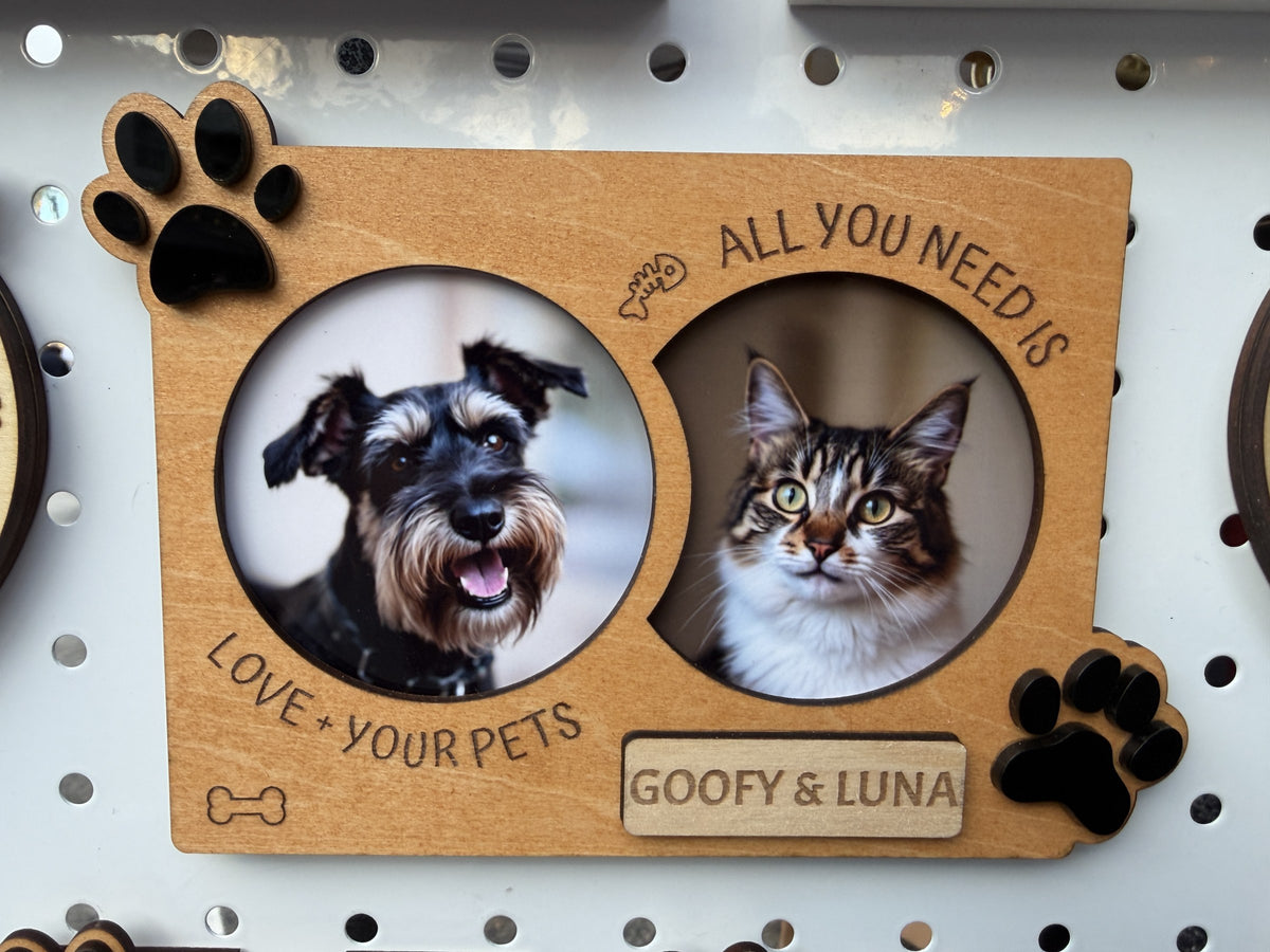 Souvenir Design wooden dog and cat photo frame with two round photos, engraved All you need is love + your pets, black paws and a name plaque reading GOOFY & LUNA