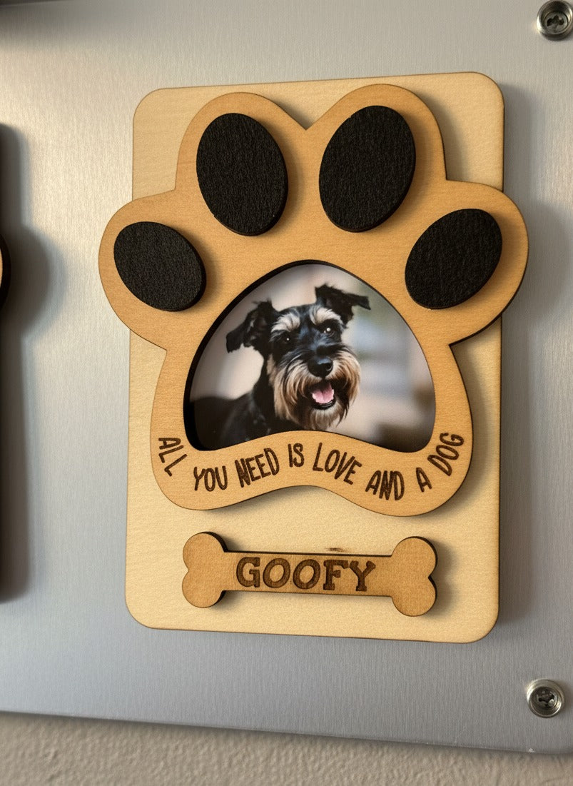 Paw print wooden photo magnet with a schnauzer photo, "All you need is love and a dog" and the name GOOFY, on a fridge